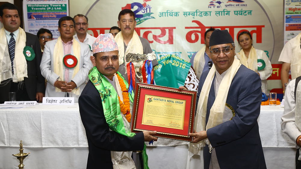 Mohan Lamsal - Tourism Man of the Year 2016, awarded by Prime Minister of Nepal Sher Bahadur Deuwa